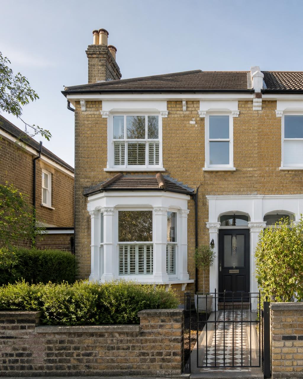 A brick semi-detached house in morning light